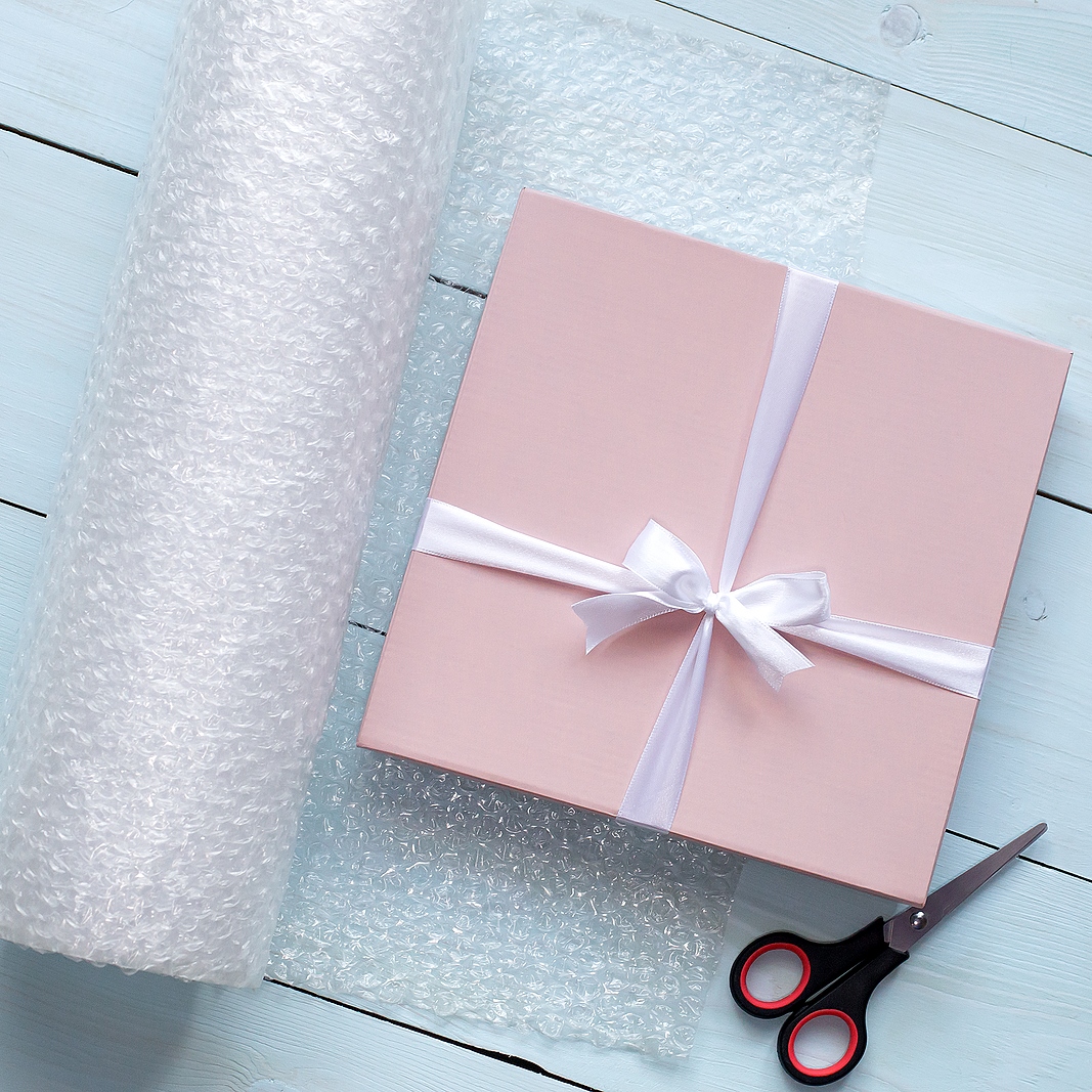 pink box with white bow, on wooden background, gift packing