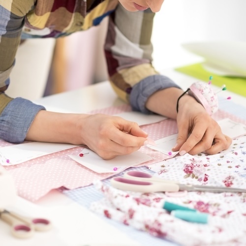 closeup on seamstress working in studio
